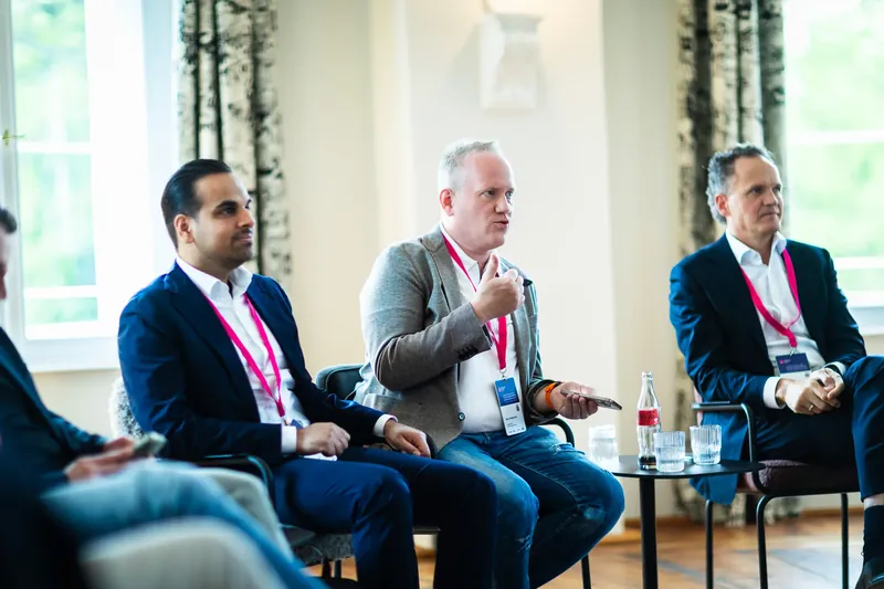 Kamran Roske, Marc Hildebrandt and Lars Neumann listening attentively during the panel session