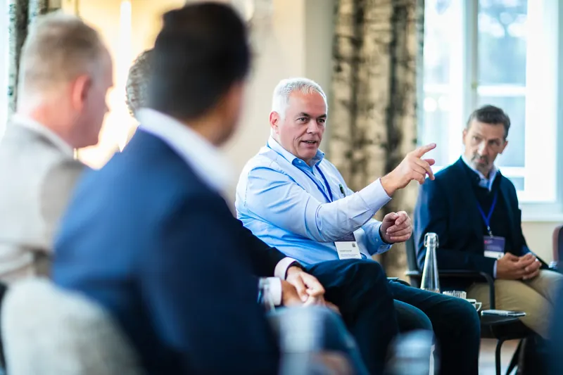 Christof Schmidt making a point alongside Dr. Stefan Poledna during the open debate