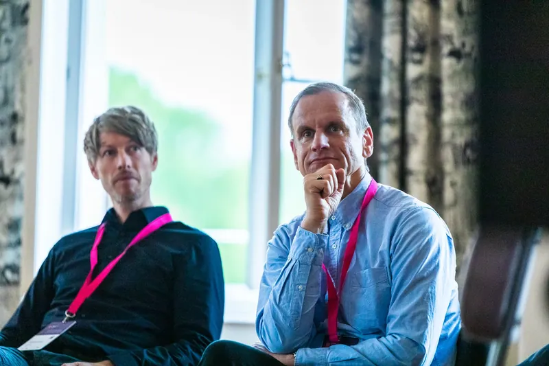 Dr. Johannes Bohnet and Oliver Viel listening intently to the panel