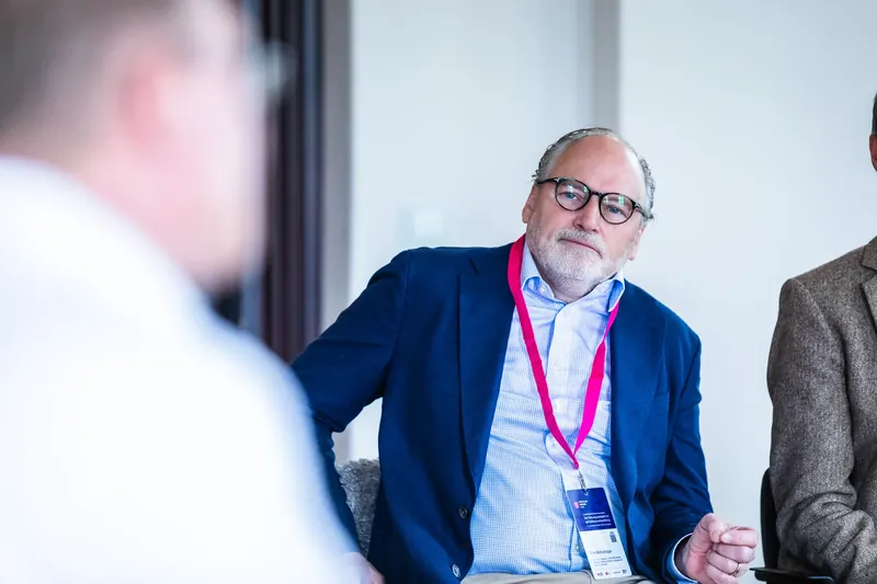 Dirk Wollschl&auml;ger listening reflectively to the discussion