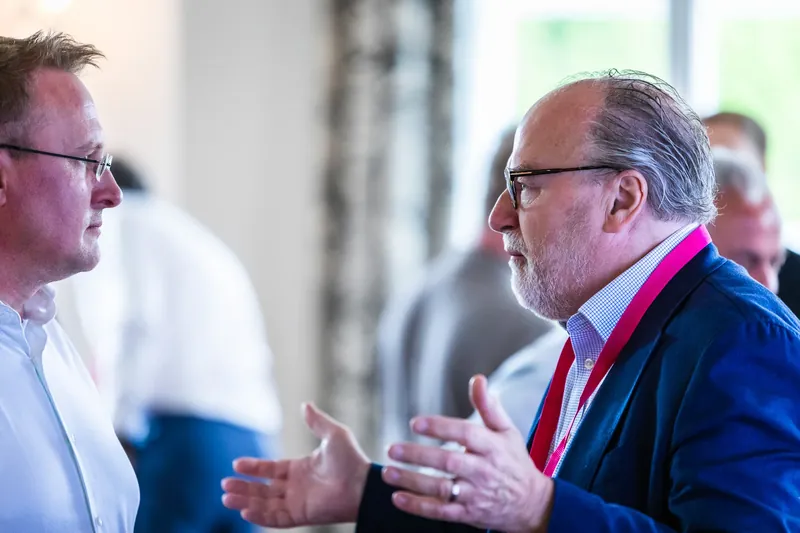 Sebastian Koch and Dirk Wollschl&auml;ger continuing the discussion in a one-on-one conversation